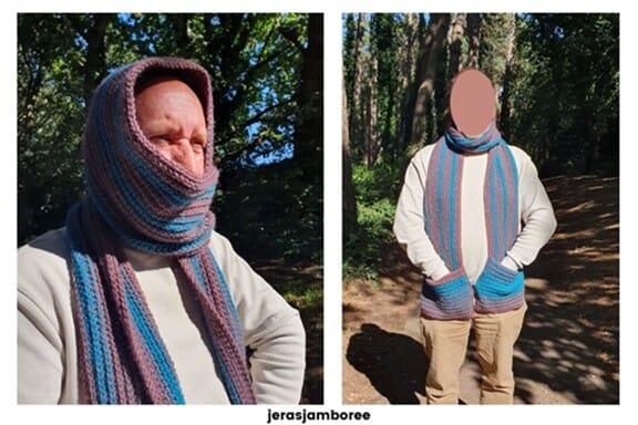 Man modelling The Glen Scarf, a chunky crochet scarf with teal and mauve ribbed stripes. On the left, the scarf is wrapped around the head and neck like a hood for extra warmth. On the right, the scarf is styled long and loose with hands in the pockets. Outdoor woodland setting with text ‘jerasjamboree’ underneath.