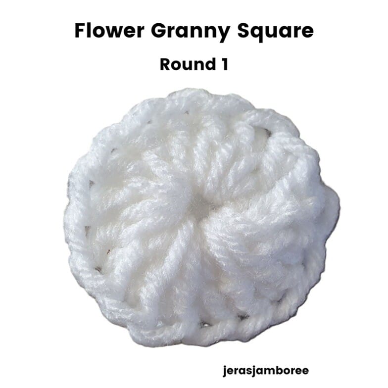 Flower Granny Square Round 1 showing the centre of the flower made with white yarn. The round forms a small, tightly stitched circle that creates the base for the crochet flower.
