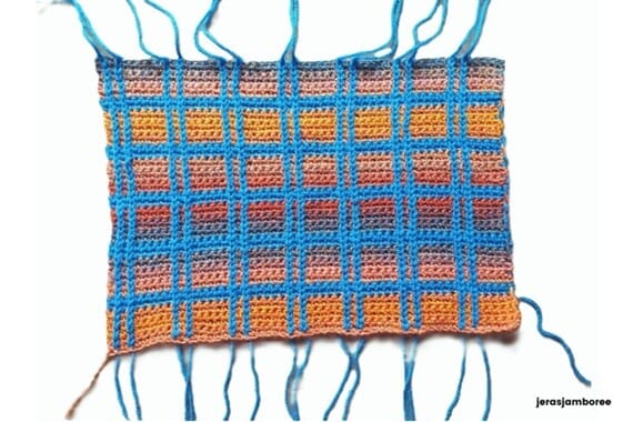 Lennox Crochet Book pouch rectangle showing completed tartan design with blue vertical surface slip stitches, yarn tails visible from surface slip stitches before weaving in.