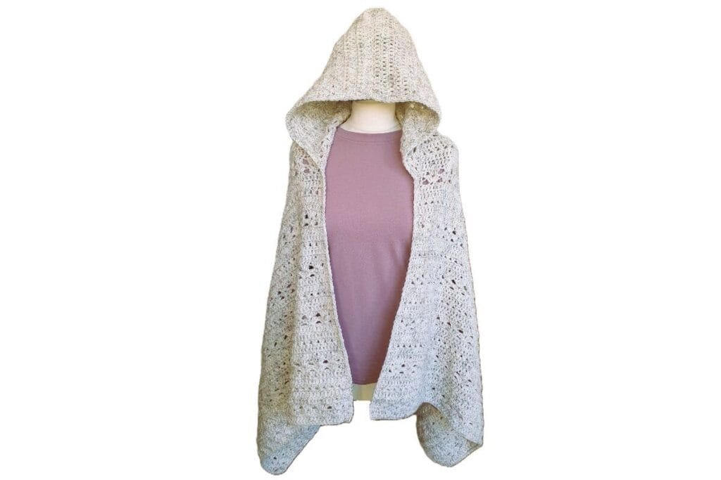 Crochet shawl with hood worn open, showing the full length and textured stitch pattern