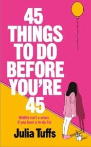 Book cover of 45 Things to Do Before You’re 45 by Julia Tuffs, featuring bold white title text on a bright pink background, with a minimalist illustration of a woman standing on a yellow floor next to a paint bucket and roller, and a yellow balloon floating above.
