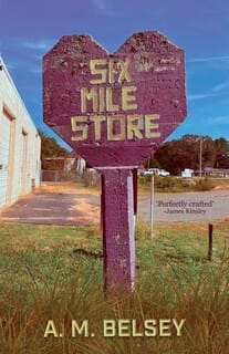Book cover for Six Mile Store by A. M. Belsey, featuring a weathered purple roadside sign shaped like a heart with the title in bold lettering, set beside a rural building and grassy verge under a blue sky.