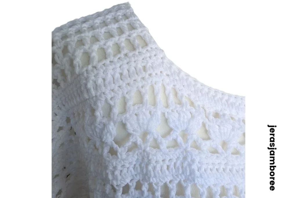Close-up of Lily crochet summer top shoulder showing mesh stitch detail, lace texture, and bobble stitches in the free crochet pattern.