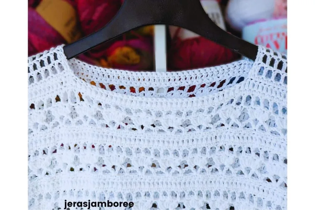 Close-up of Lily crochet summer top pattern showing lacy stitch detail, including bobble stitches, V-stitch pattern, and mesh shoulder section.