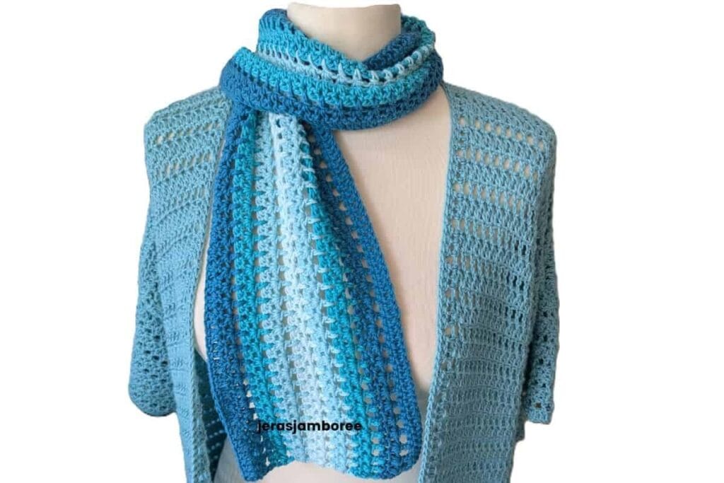 The Sandrine Scarf worn with the matching Sandrine Cardigan, showing the lightweight mesh stitch and coordinating blue colour palette.