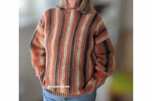 Rowan Ridge crochet sweater being worn, showing the relaxed fit, vertical stripes, ribbed cuffs and hem.