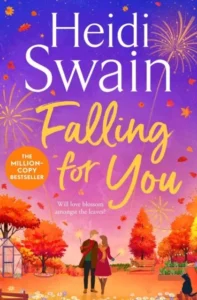 Book cover of Falling For You by Heidi Swain, featuring a couple walking together through an autumn park, surrounded by colourful trees and falling leaves beneath a purple sunset sky.